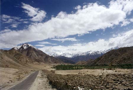 A mani wall leading to a Buddhist village